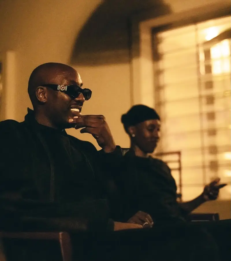Bien of Sauti Sol smiles during the listening session, Theecember seated behind him