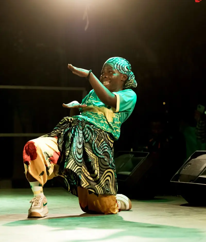 Une danseuse en tenue verte, un genou à terre